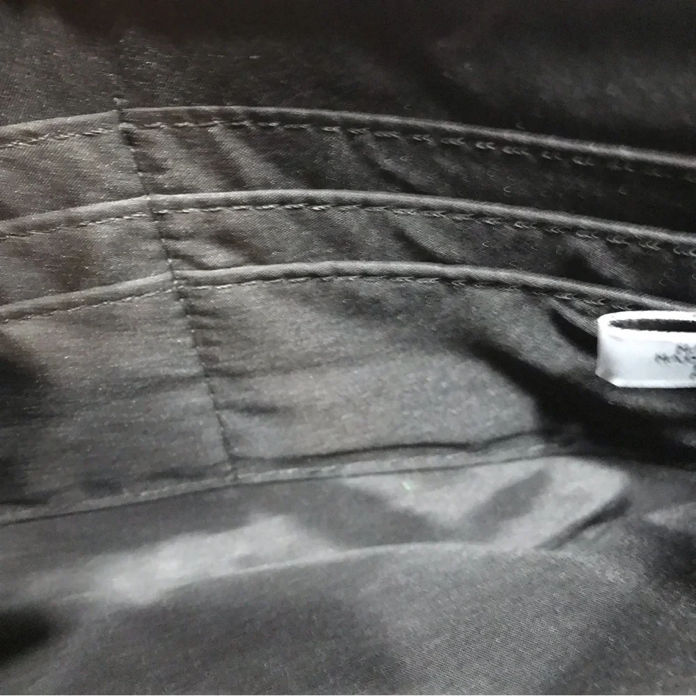 Nine West Black and White Cutout Flower Wristlet. - Picture 3 of 4